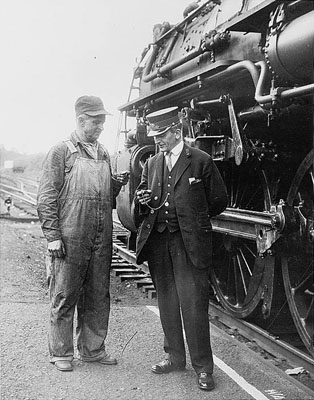 Conductor and Engineer compare time circa 1930, U.S. Library of Congress collection