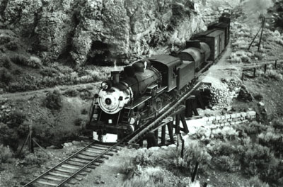 V&T Locomotive No. 5 pulls a train along the main line track through a canyon